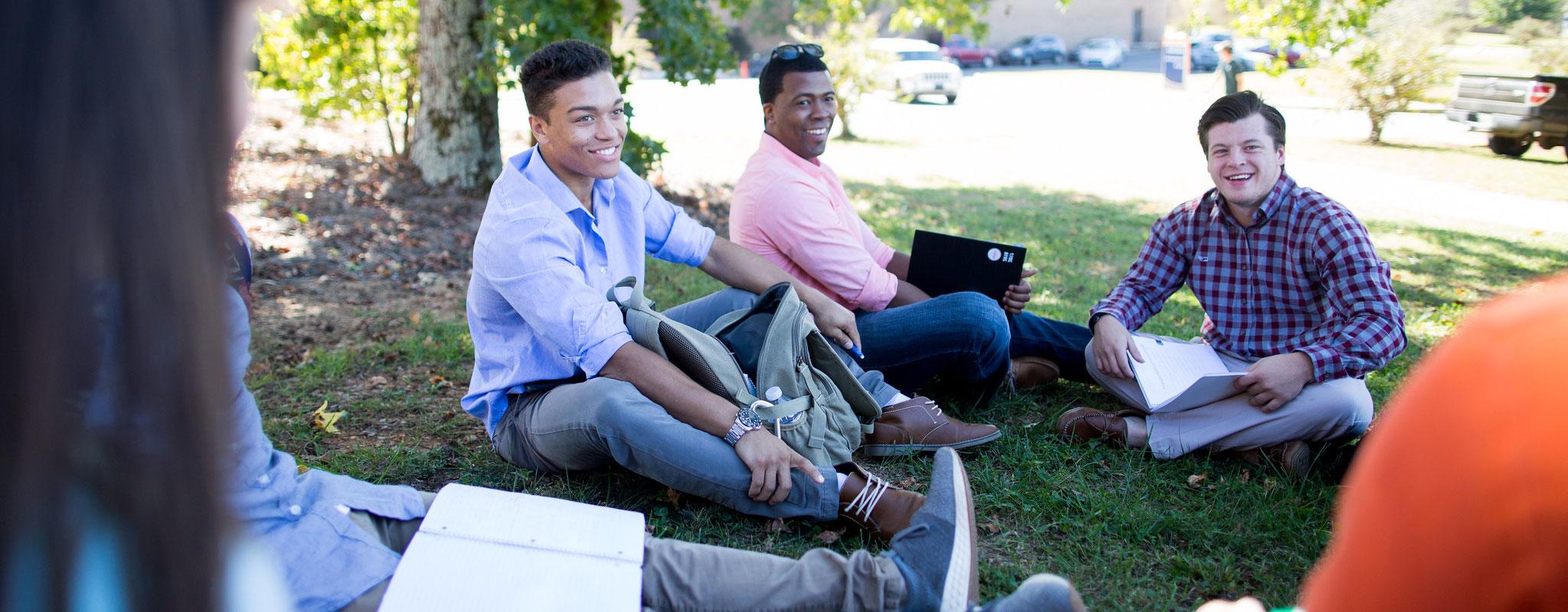 students sitting outside